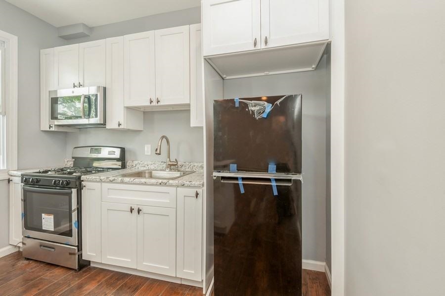 705 8th Street, Unit 2 Union City, NJ 07087 - Photo 7 of 19 a kitchen with a sink and cabinets