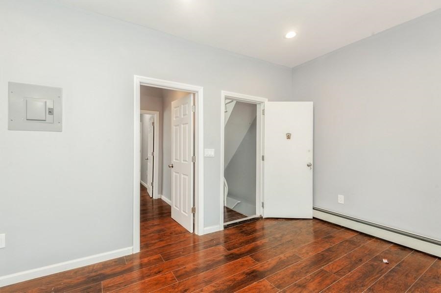 705 8th Street, Unit 2 Union City, NJ 07087 - Photo 10 of 19 a view of an empty room with wooden floor and closet