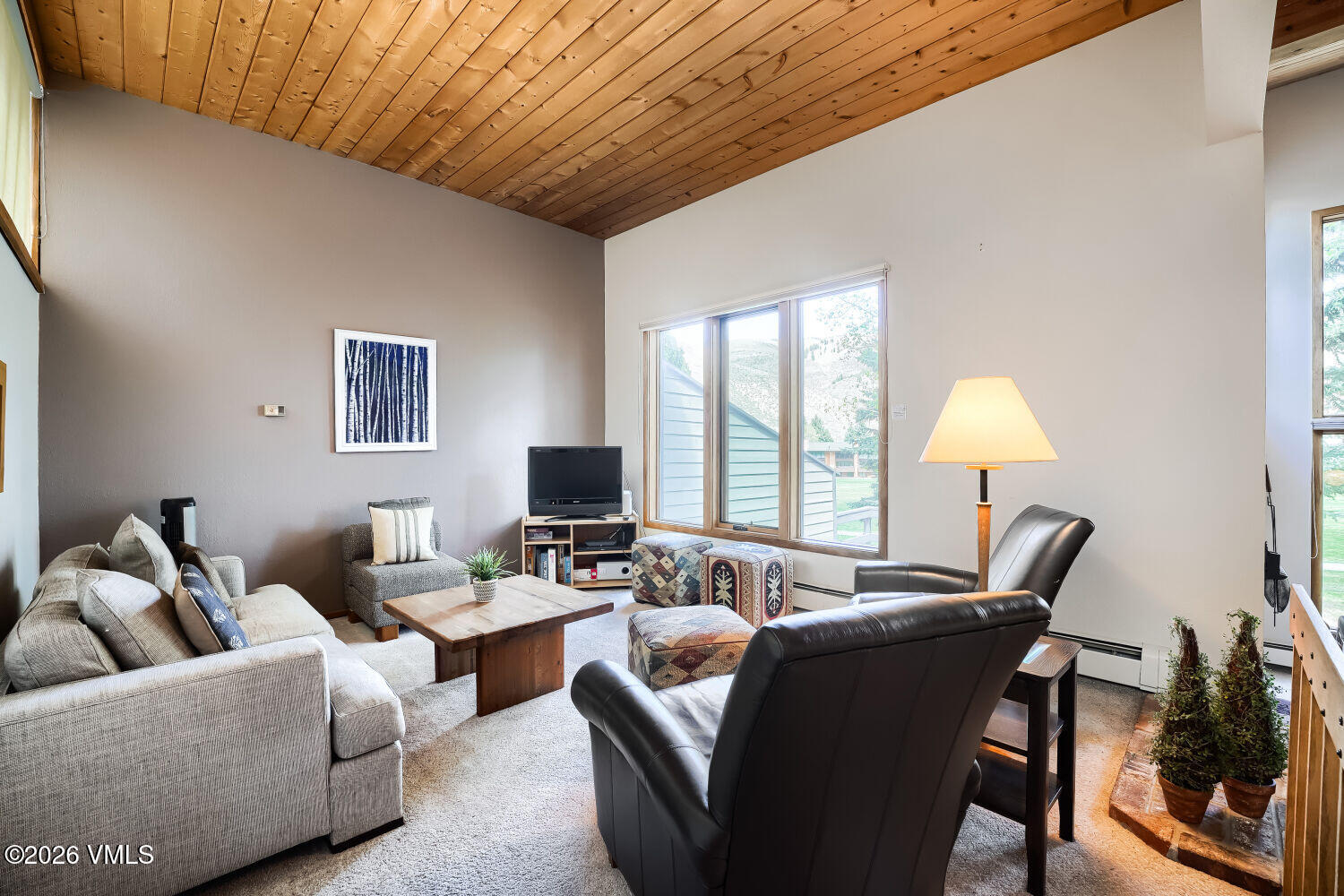 128 Beaver Road, Unit EAST Eagle-Vail, CO 81620 - Photo 8 of 21 a living room with furniture and a flat screen tv