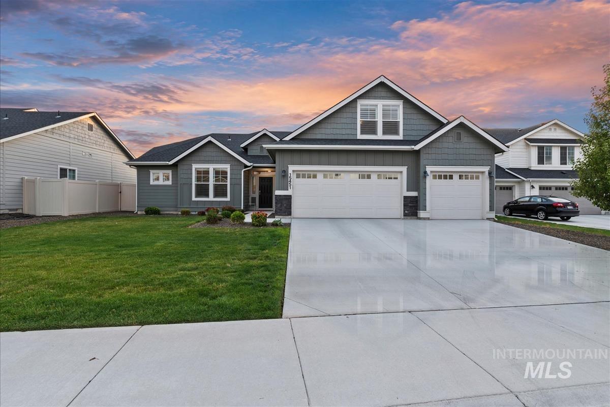 15451 Lutsen Avenue Caldwell, ID 83607 - Photo 2 of 39 Contemporary siding exterior featuring a three-car garage, concrete driveway, front lawn, and foundational landscaping