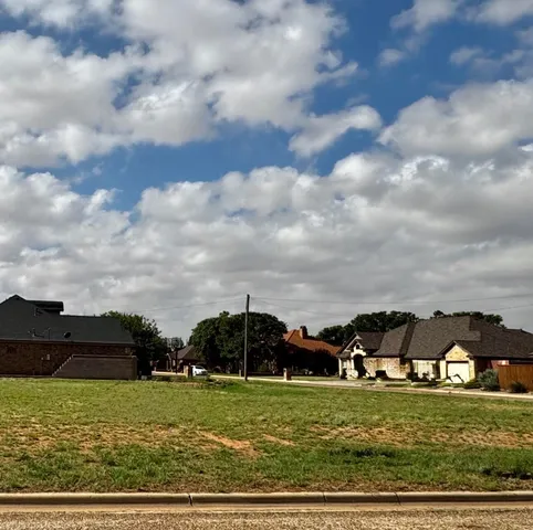 a view of a big yard with houses