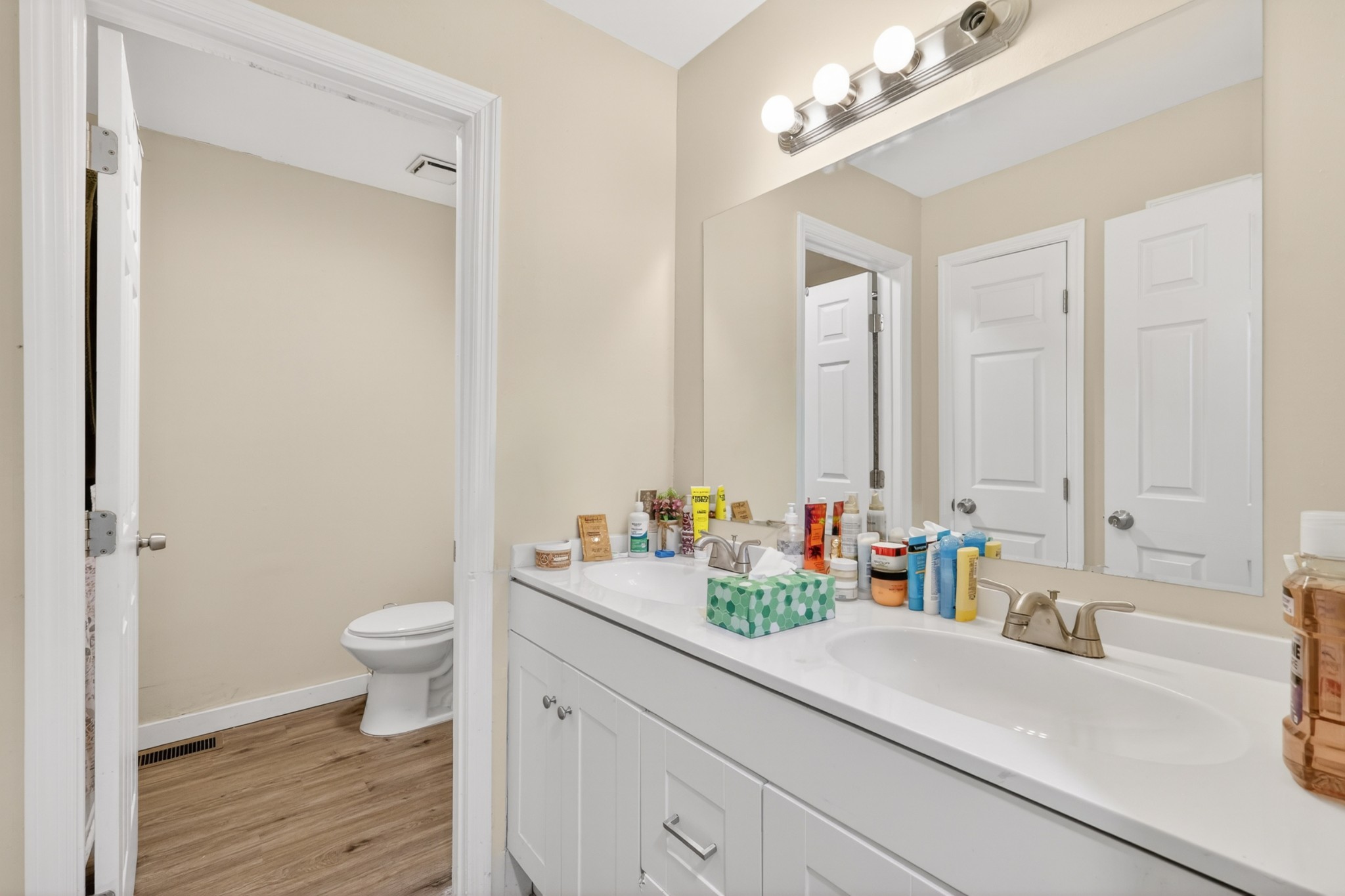 1314 Bellshire Terrace Drive Nashville, TN 37207 - Photo 8 of 15 a bathroom with a sink a toilet and a large mirror