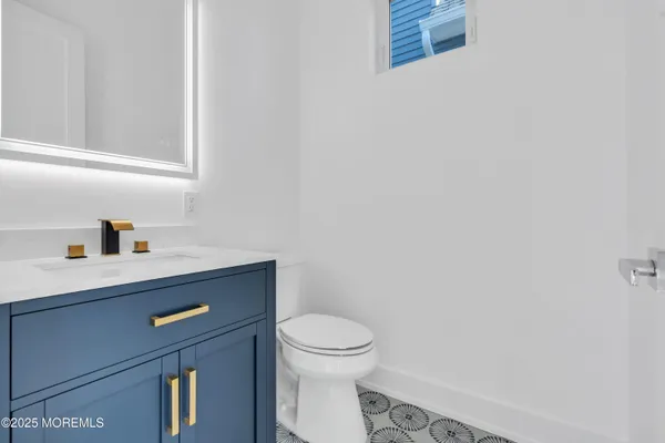 a bathroom with a sink a toilet and vanity