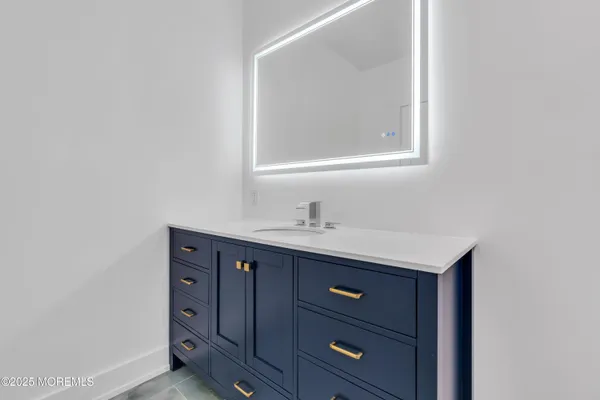 a bathroom with a sink vanity and mirror