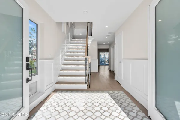 a view of entryway and hall with wooden floor