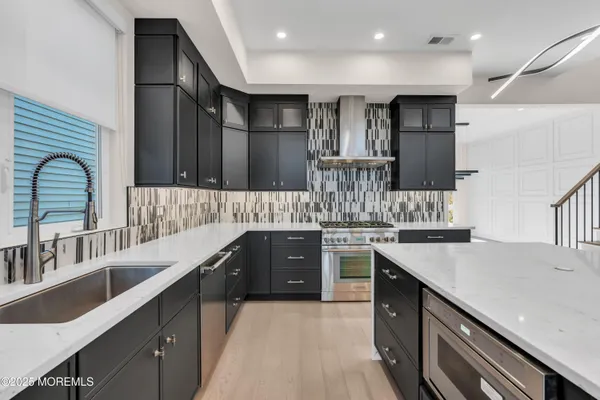 a kitchen with stainless steel appliances kitchen island granite countertop a sink and cabinets