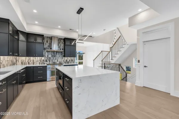 a kitchen with a sink a counter top space stainless steel appliances and a window