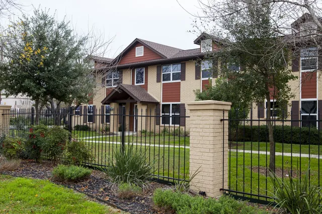 a view of a house with a garden and plants