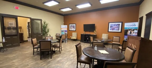 a living room with furniture a flat screen tv and a table