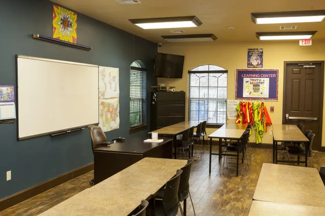 a living room with dining room and kitchen view
