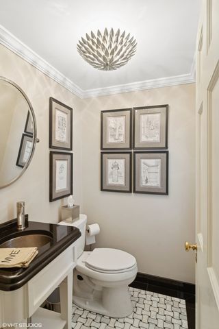 a bathroom with a granite countertop sink mirror vanity and toilet
