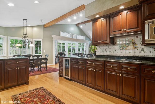 a kitchen with stainless steel appliances granite countertop wooden cabinets a sink and dishwasher