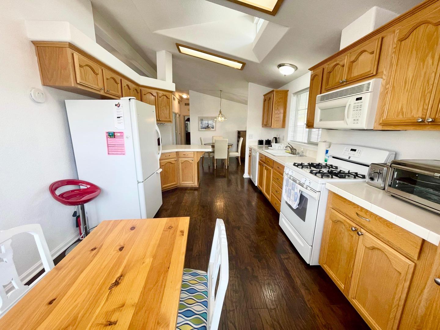 711 Old Canyon Road, Unit 13 Fremont, CA 94536 - Photo 11 of 26 a kitchen with stainless steel appliances sink stove top oven and cabinets