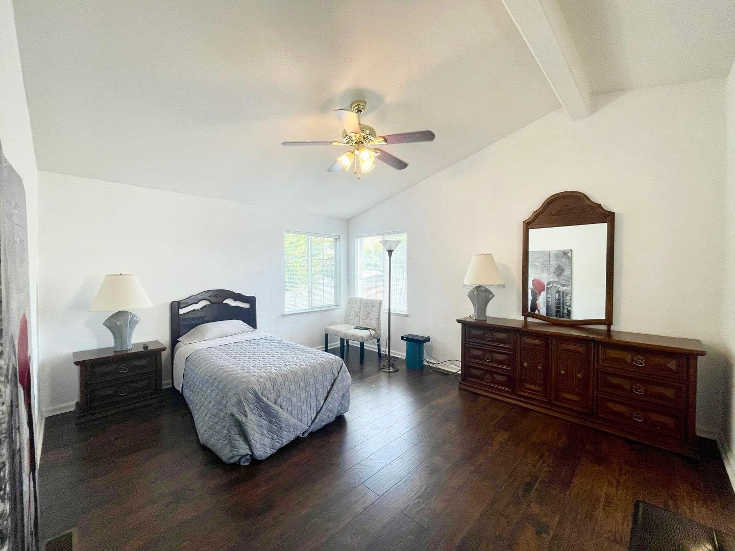 711 Old Canyon Road, Unit 13 Fremont, CA 94536 - Photo 17 of 26 a bedroom with a bed and wooden floor