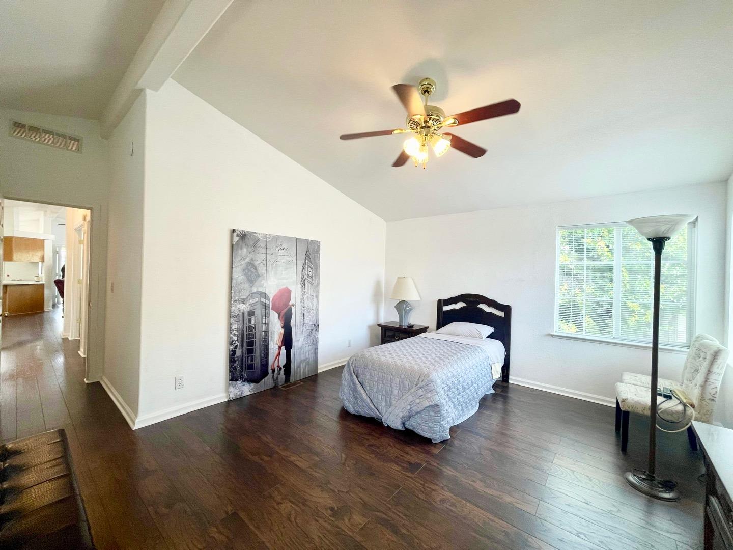 711 Old Canyon Road, Unit 13 Fremont, CA 94536 - Photo 19 of 26 a bedroom with a bed and wooden floor