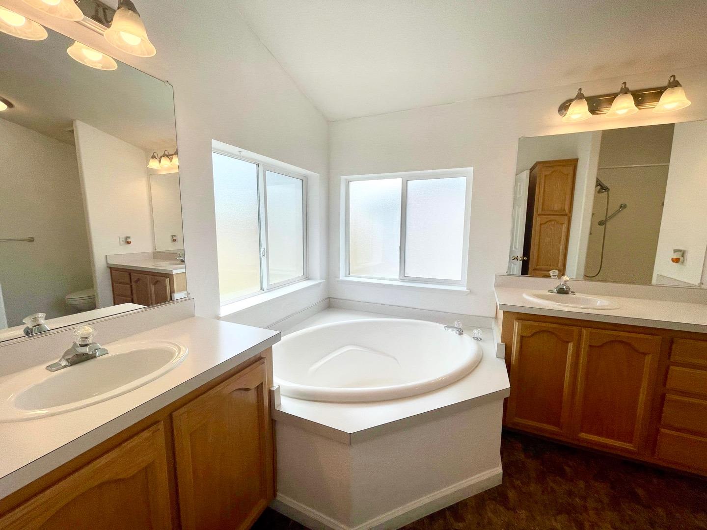 711 Old Canyon Road, Unit 13 Fremont, CA 94536 - Photo 22 of 26 a bathroom with a tub sink and mirror