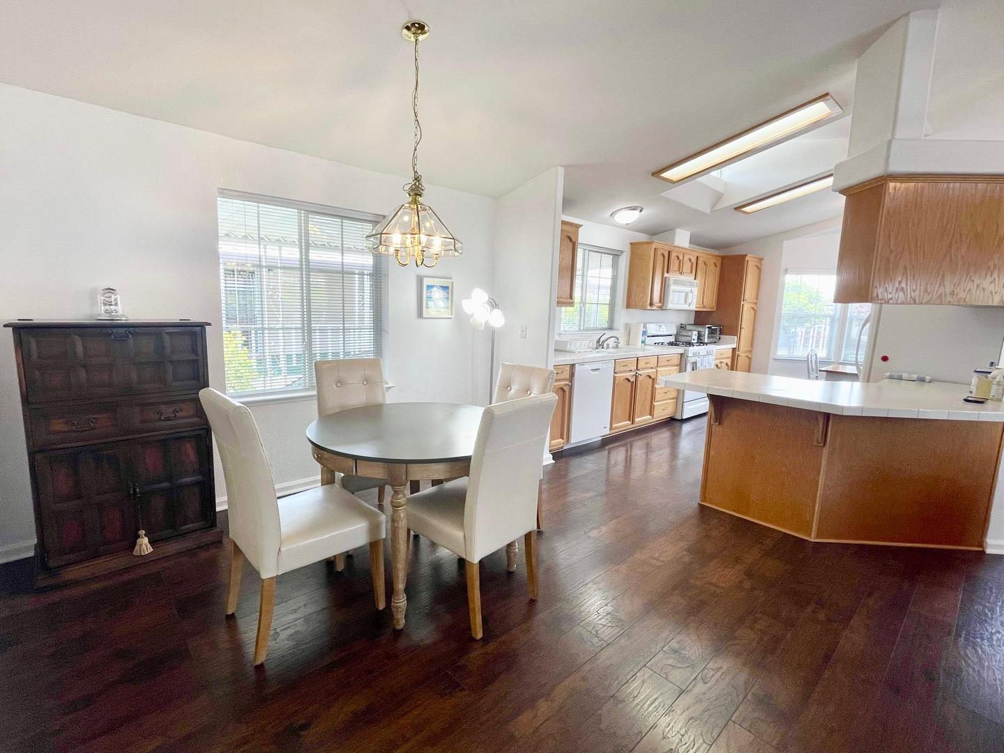 711 Old Canyon Road, Unit 13 Fremont, CA 94536 - Photo 4 of 26 a view of a dining room with furniture window and wooden floor