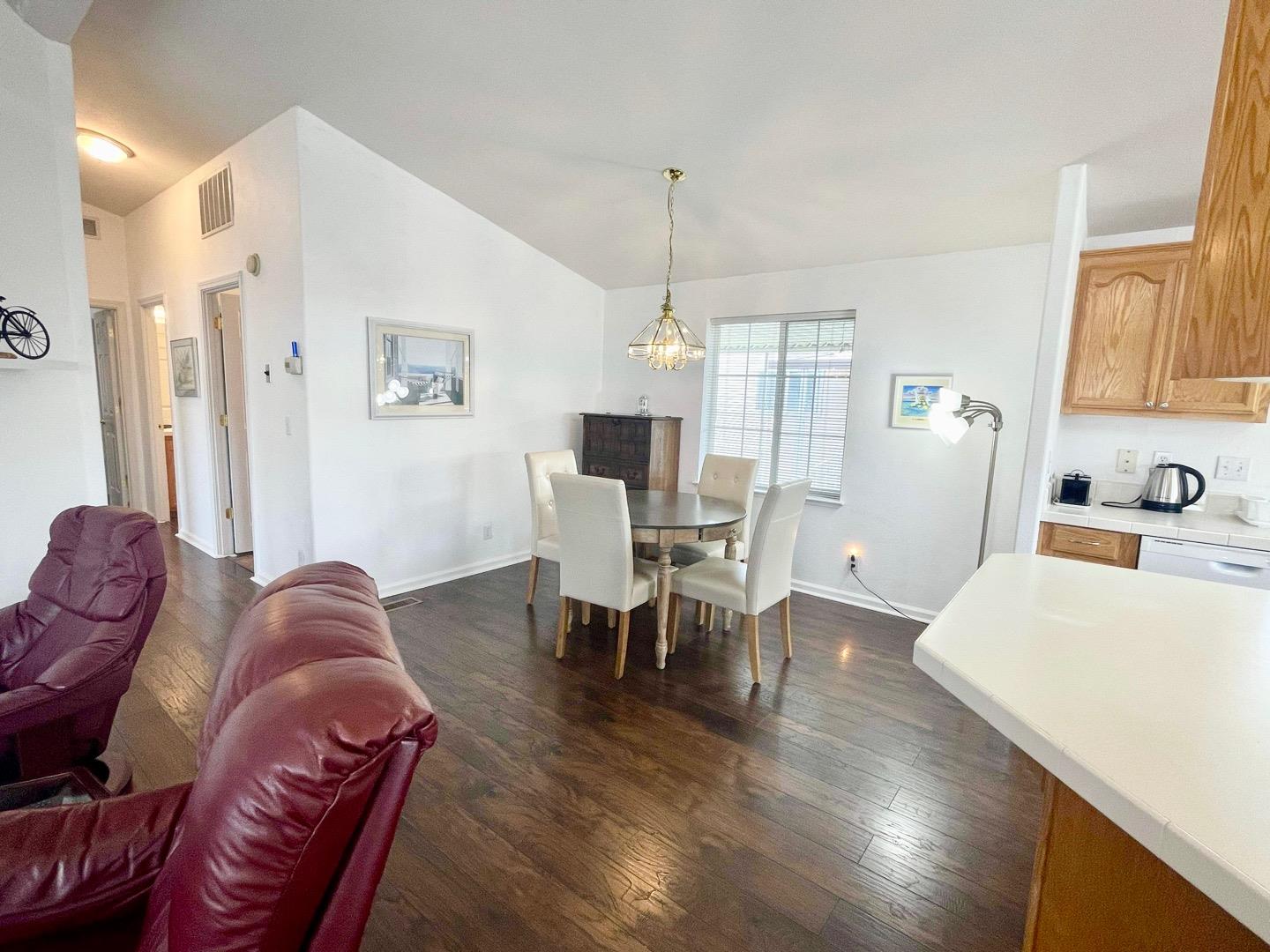 711 Old Canyon Road, Unit 13 Fremont, CA 94536 - Photo 6 of 26 a living room with furniture a dining table and a chandelier