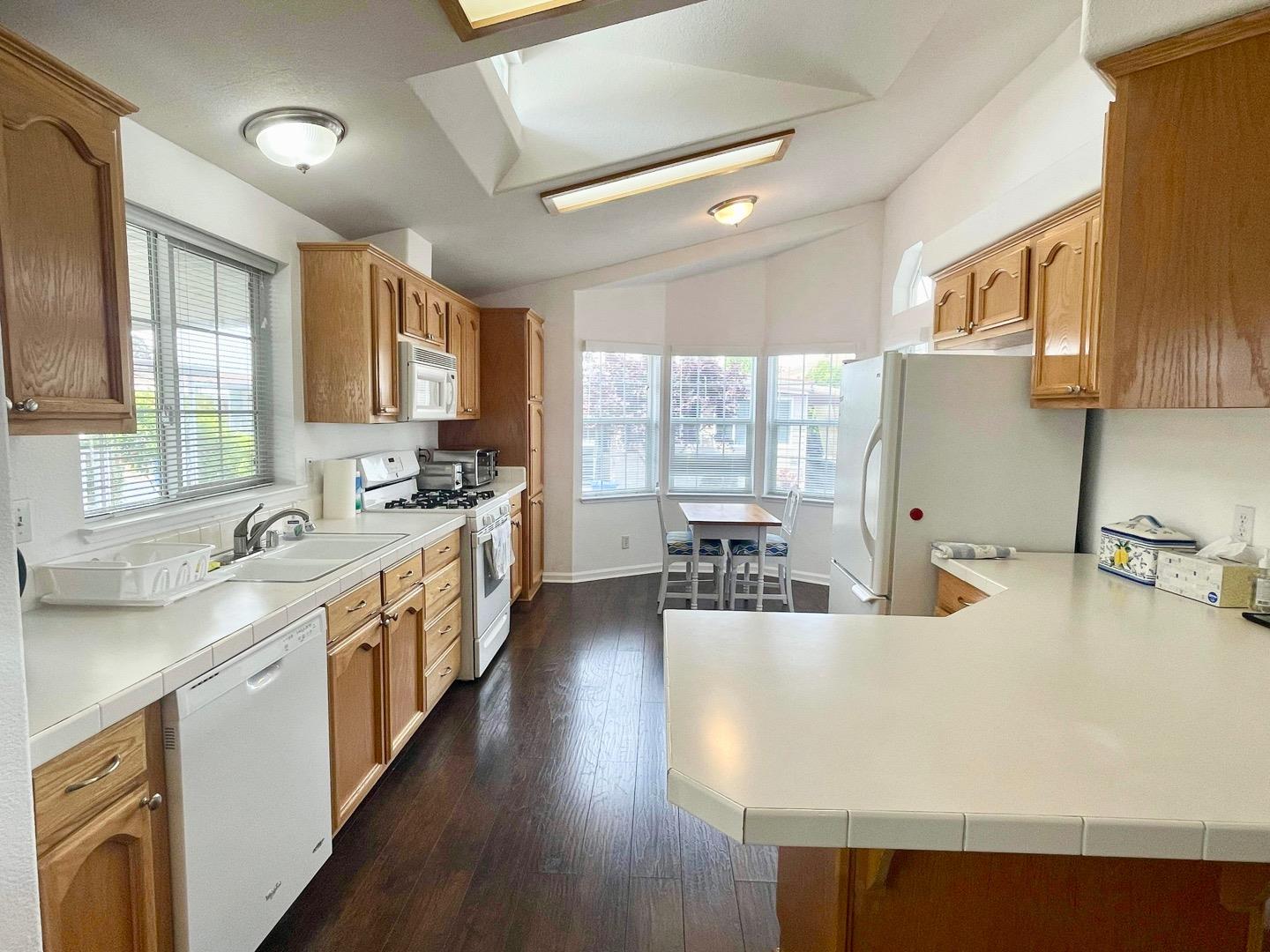 711 Old Canyon Road, Unit 13 Fremont, CA 94536 - Photo 7 of 26 a kitchen with counter top space and wooden floor