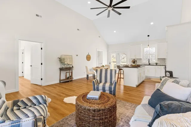 an empty room with a window and ceiling fan