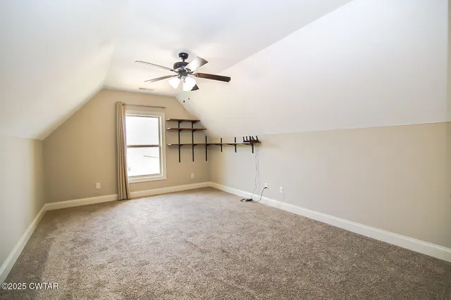 a view of empty room with ceiling fan