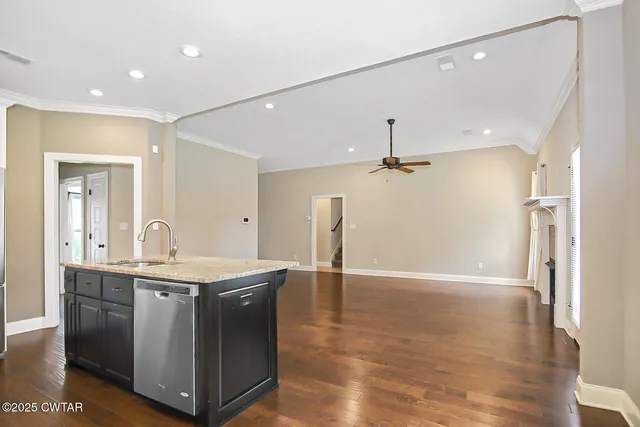 a view of a kitchen with a sink wooden floor and a chandelier