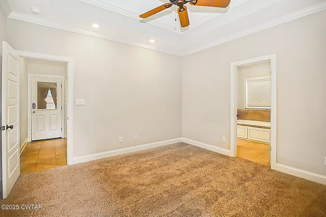 an empty room with fan and entrance