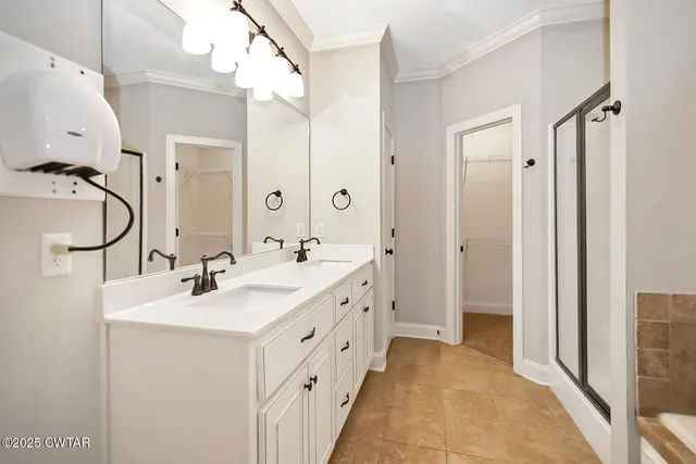 a bathroom with a double vanity sink a mirror and a shower