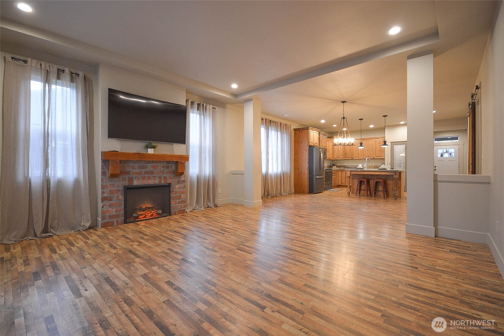 259 Parkside Loop Chehalis, WA 98532 - Photo 17 of 39 a view of a livingroom with a fireplace wooden floor and windows