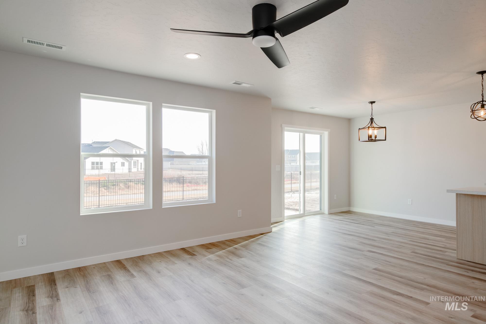 2462 West Fallon Loop Nampa, ID 83651 - Photo 11 of 23 Unfurnished living room with a ceiling fan, light wood-style flooring, and recessed lighting