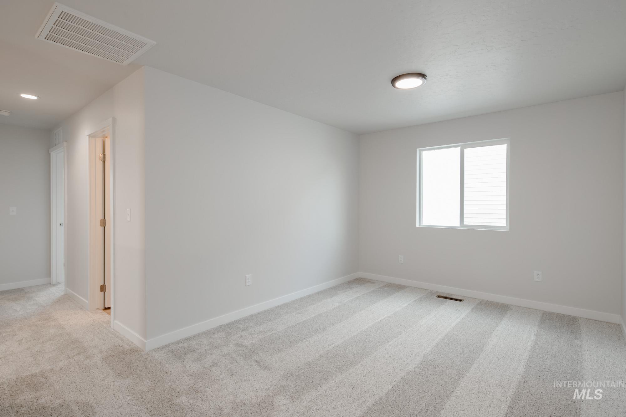 2462 West Fallon Loop Nampa, ID 83651 - Photo 17 of 23 Spare room featuring light colored carpet and baseboards