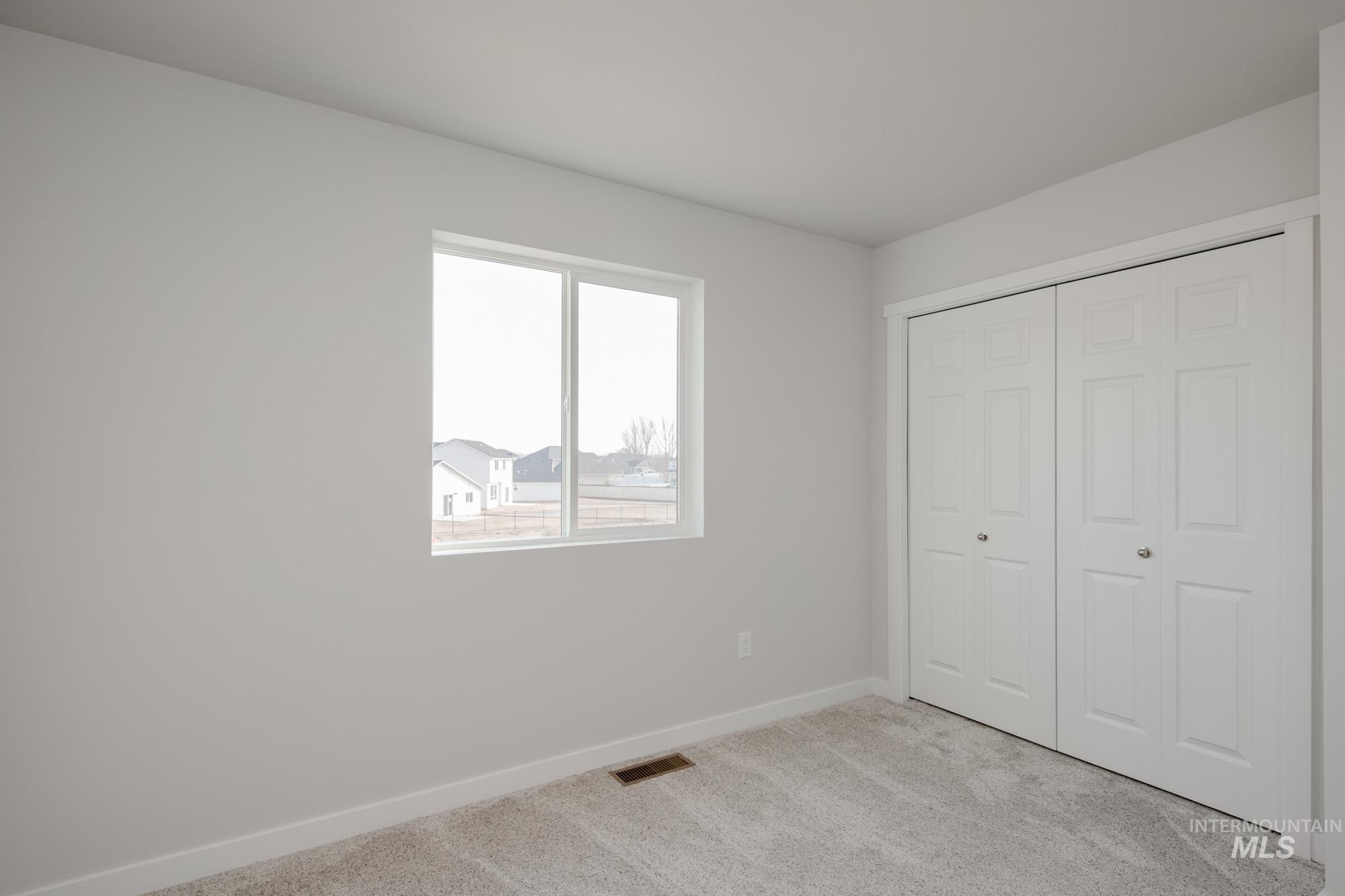 2462 West Fallon Loop Nampa, ID 83651 - Photo 19 of 23 Unfurnished bedroom with light colored carpet and a closet