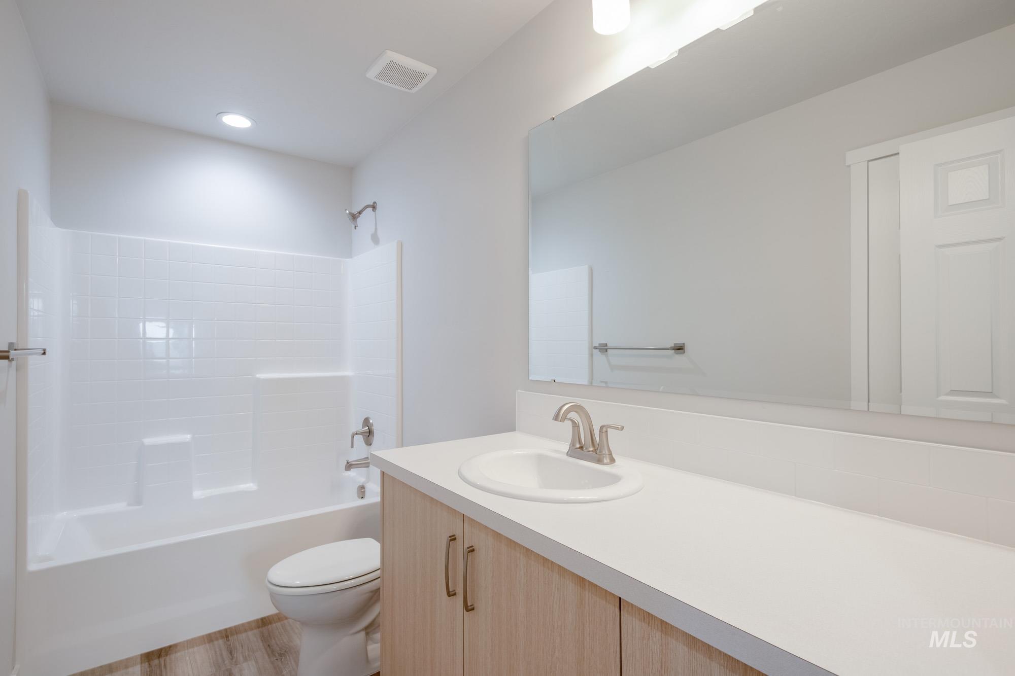 2462 West Fallon Loop Nampa, ID 83651 - Photo 20 of 23 Bathroom with shower combination, vanity, and light wood-style floors