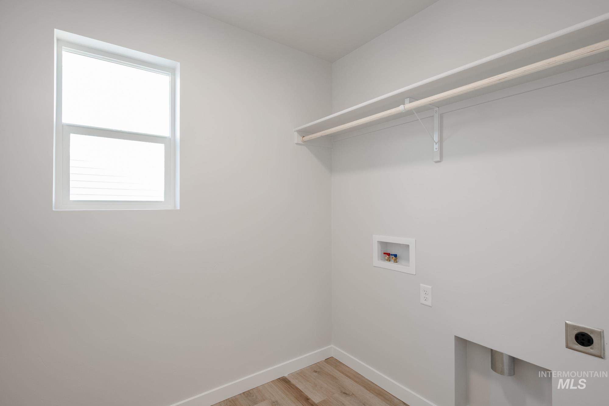 2462 West Fallon Loop Nampa, ID 83651 - Photo 21 of 23 Laundry area with light wood-type flooring, washer hookup, and hookup for an electric dryer