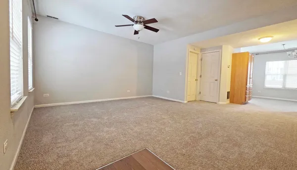 a view of a livingroom with a ceiling fan and window