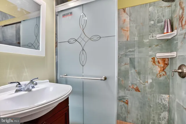 a bathroom with a sink and mirror