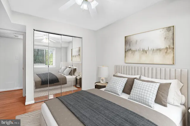 a bedroom with a bed and a painting on the wall