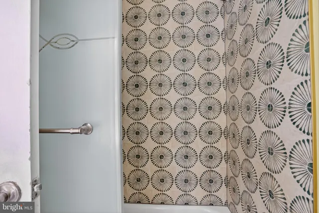 a bathroom with a shower curtain and a curtain