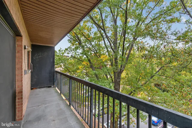 a view of a balcony with wooden fence