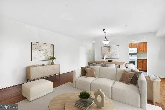 a living room with furniture a couch and painting on the wall