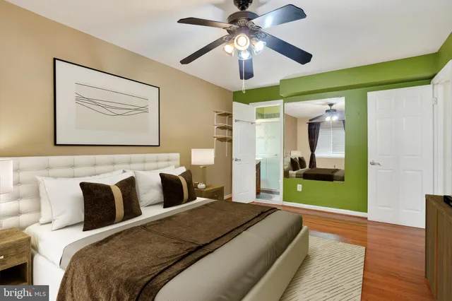 a bedroom with a large bed and a chandelier