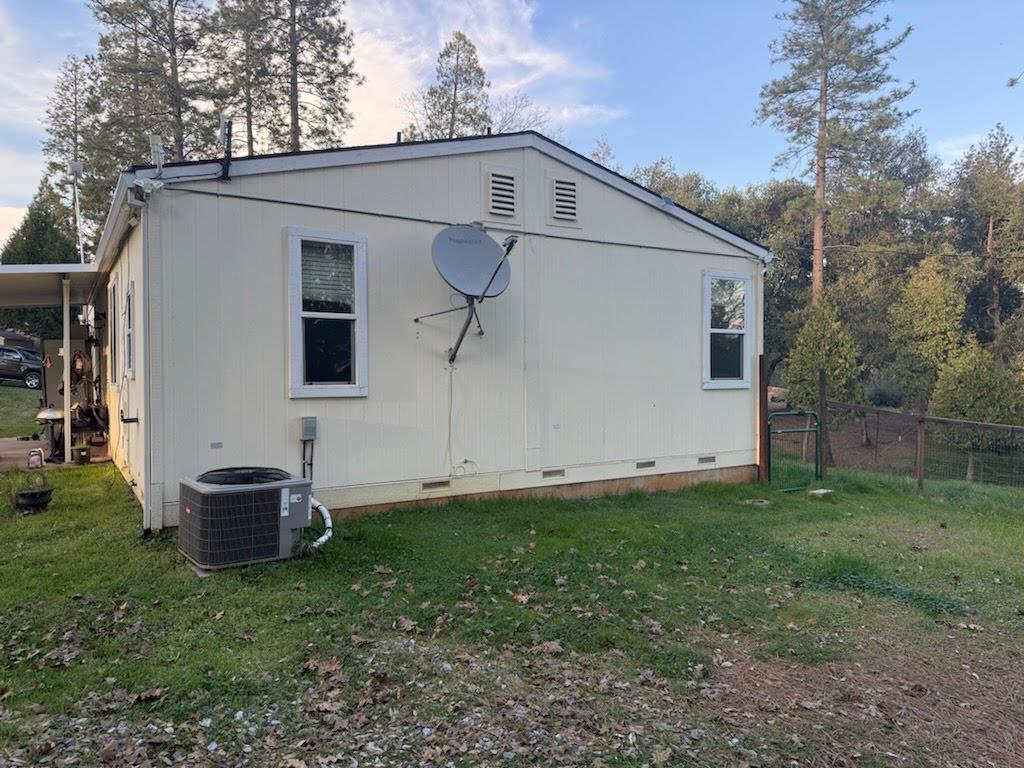18147 Old Greek Mine Road Mokelumne Hill, CA 95245 - Photo 2 of 2 a front view of a house with a garden