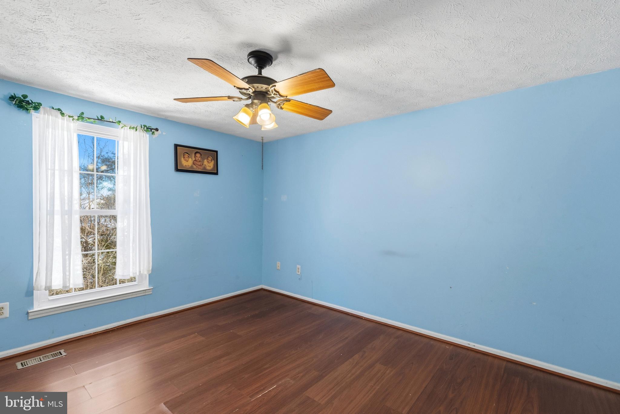 721 Rainbow Court Edgewood, MD 21040 - Photo 16 of 25 an empty room with wooden floor fan and windows
