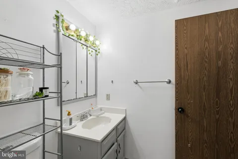 a bathroom with a sink and mirror