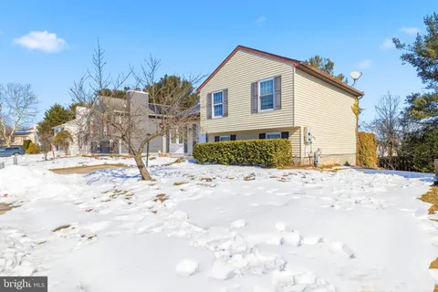 a view of a house with snow on the road