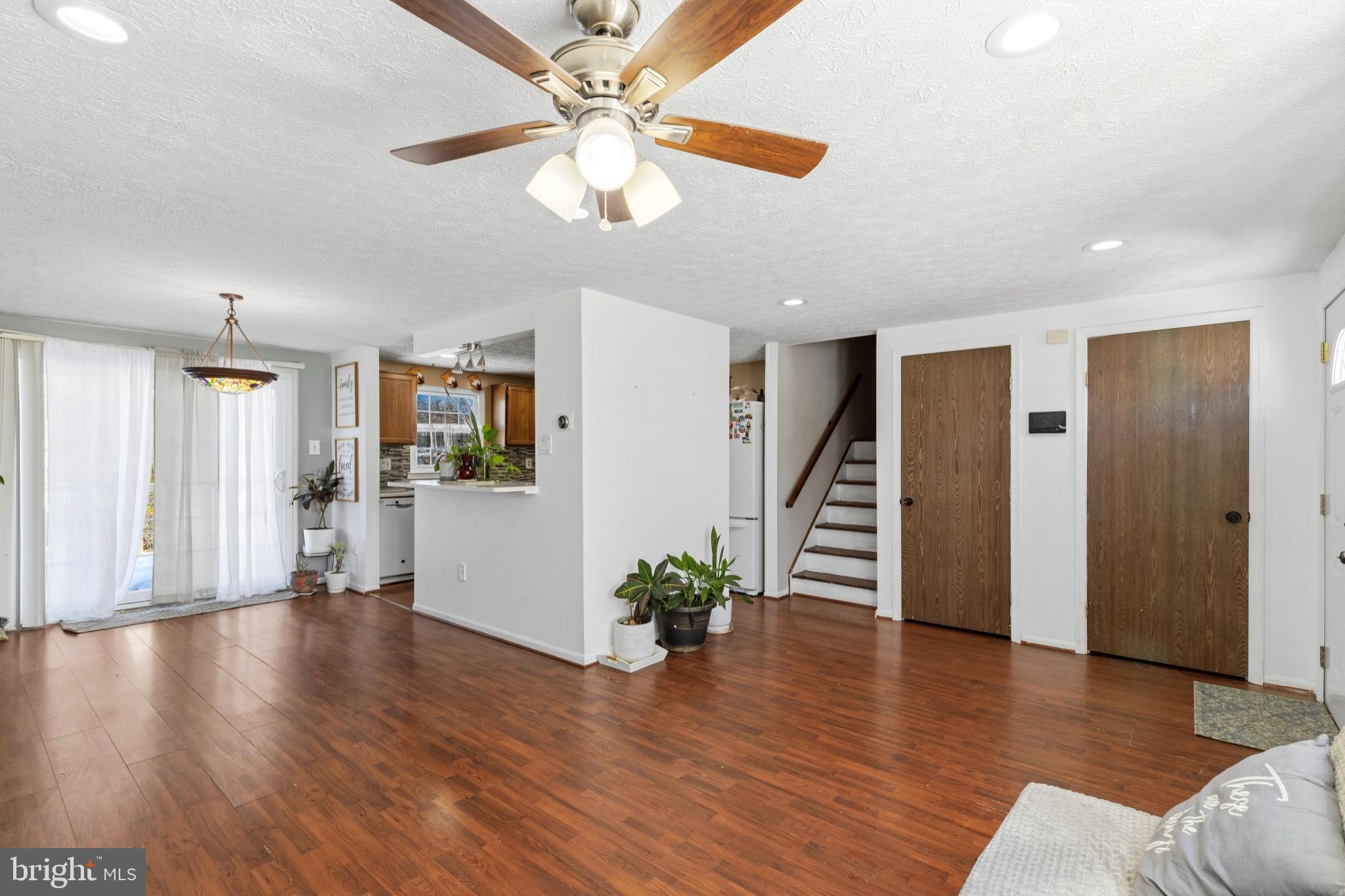 721 Rainbow Court Edgewood, MD 21040 - Photo 4 of 25 a view of a livingroom with wooden floor and a ceiling fan
