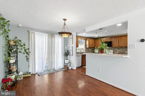 a view of a kitchen with furniture and wooden floor