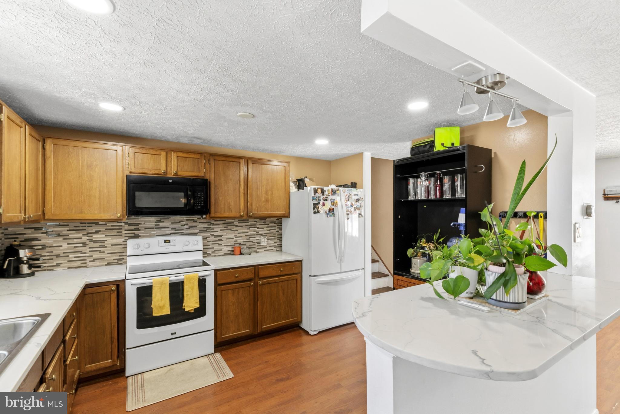 721 Rainbow Court Edgewood, MD 21040 - Photo 8 of 25 a kitchen with stainless steel appliances kitchen island granite countertop a refrigerator a stove and a sink