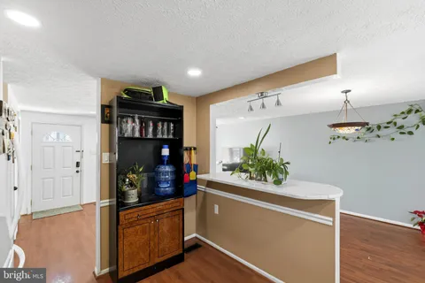 a kitchen with stainless steel appliances granite countertop a refrigerator and a stove