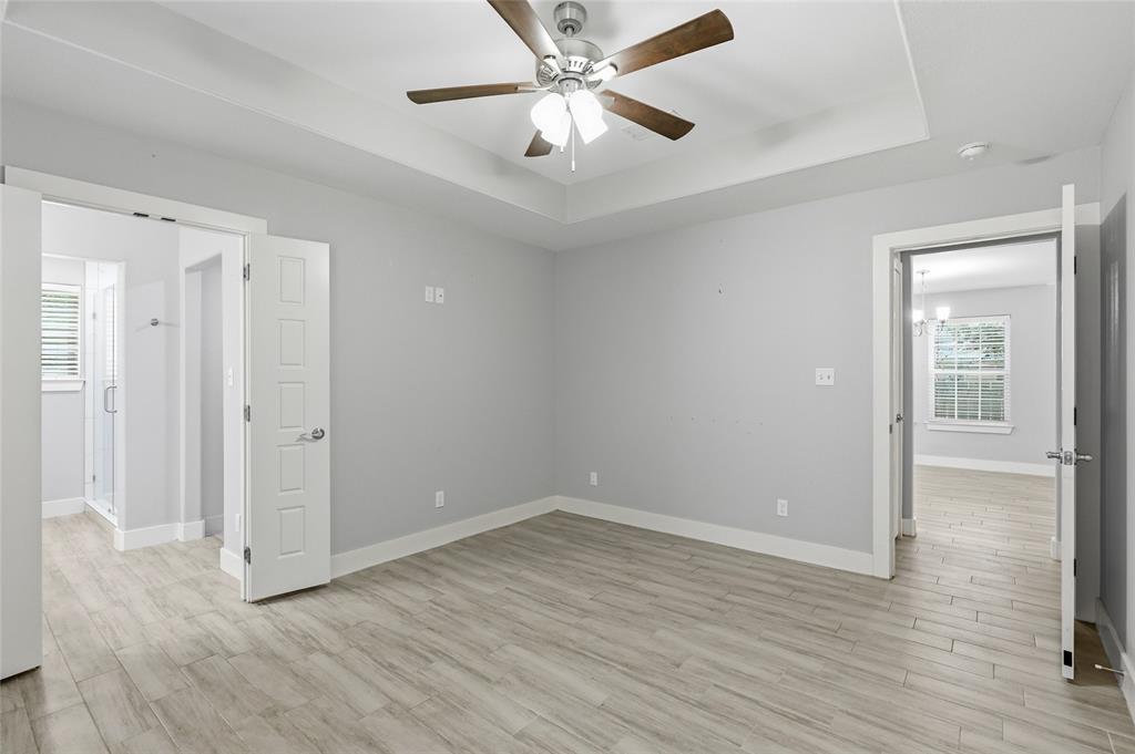 318 Munson Street Denison, TX 75021 - Photo 10 of 21 wooden floor in an empty room with a window